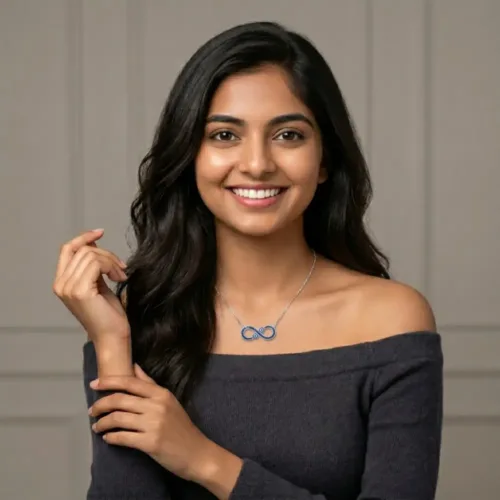Smiling Indian woman wearing the elegant evil eye infinity necklace for women paired with a casual dark top