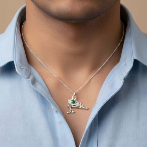 Man wearing silver Krishna flute pendant necklace with peacock leaf motif