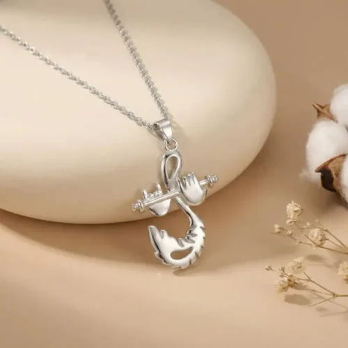 Elegant Krishna Bansuri Pendant resting gracefully on a smooth cream stone surrounded by delicate dried flowers, highlighting its pure stone-free silver finish.