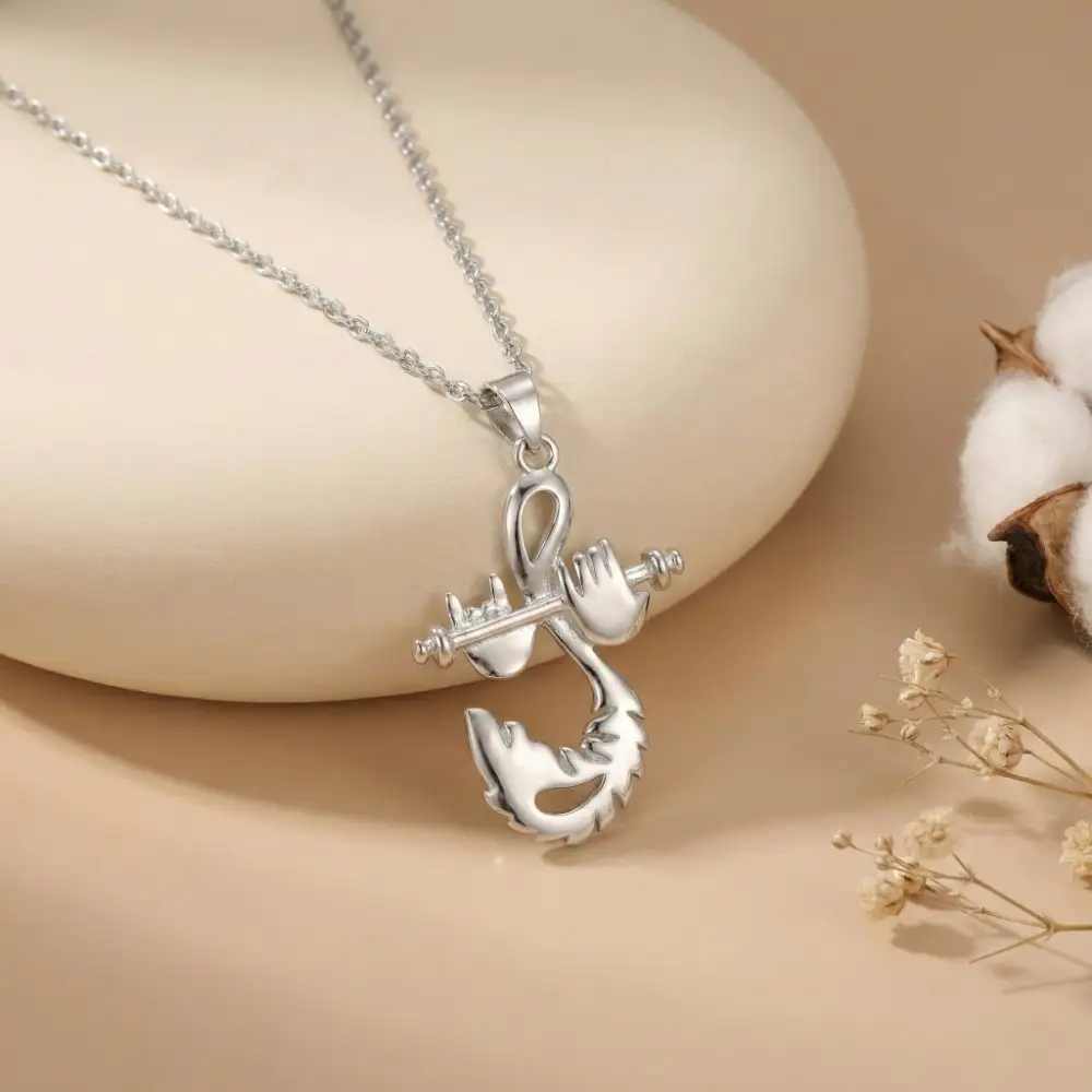 Elegant Silver Krishna Murli Locket Elegant Krishna Bansuri Pendant resting gracefully on a smooth cream stone surrounded by delicate dried flowers, highlighting its pure stone-free silver finish.