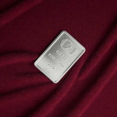 2 gram silver bar made from 999 pure silver displayed on maroon fabric background