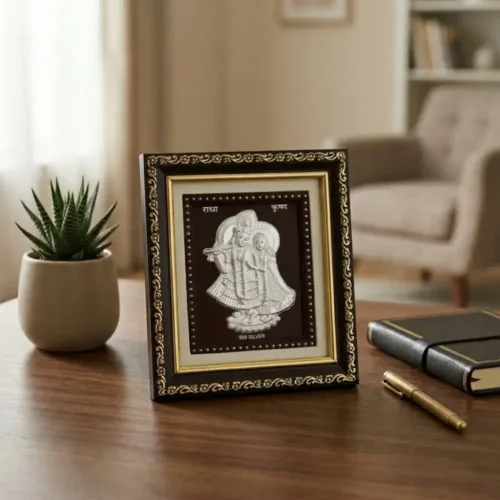 999 pure Silver Radha Krishna Frame placed elegantly on a wooden table for home decor and mandir
