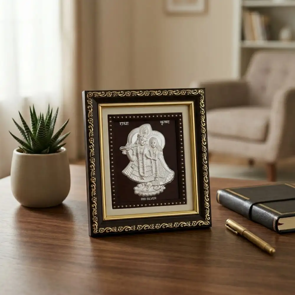 Silver Radha Krishna Frame for Home Decor and Mandir 999 pure Silver Radha Krishna Frame placed elegantly on a wooden table for home decor and mandir