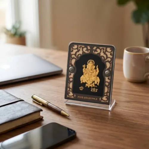 Beautiful pure 24k gold foil ganesh idol with acrylic frame placed elegantly on an office desk