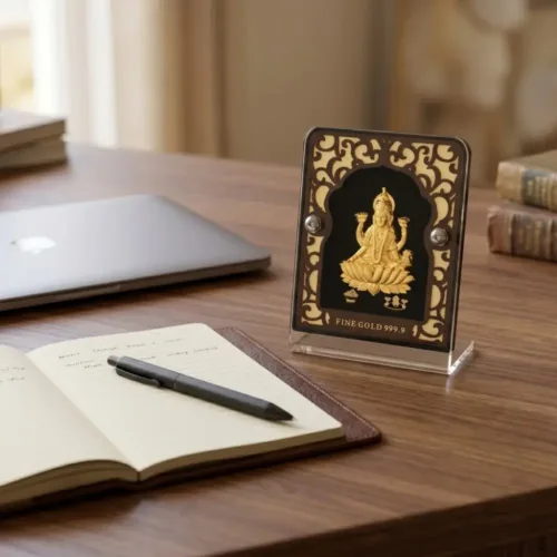 Beautiful pure 24k gold foil laxmi idol with acrylic frame placed elegantly on an office desk to attract wealth