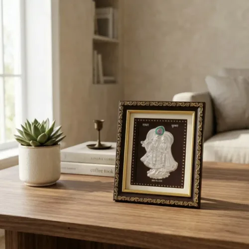 999 pure Silver Radha Krishna Frame placed elegantly on a wooden table for home decor and mandir
