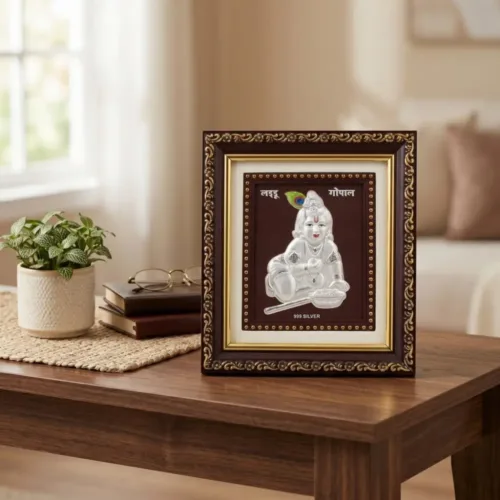 Beautifully placed silver god frame for puja room decor resting elegantly on a wooden table