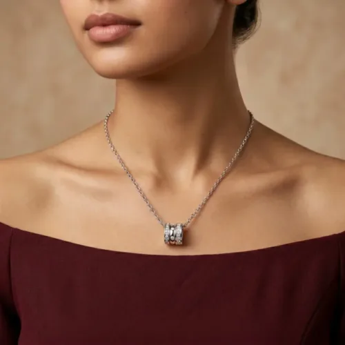 Elegant woman wearing the beautifully crafted silver three ring pendant gift for her paired with a maroon top