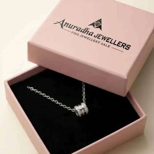Premium pink Anuradha Jewellers box presenting the beautiful silver three ring pendant gift for her