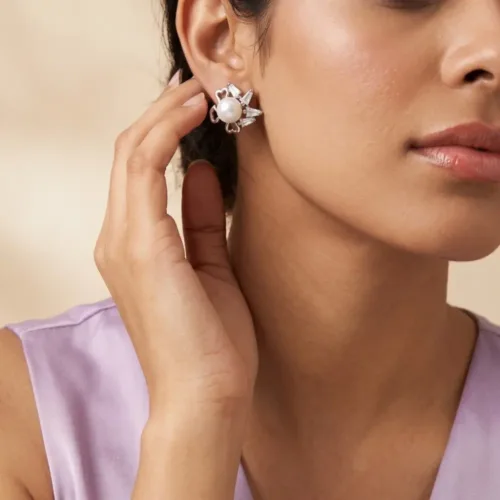 Elegant model wearing the pearl and baguette stud earrings, demonstrating the comfortable fit and modern aesthetic on the earlobe.