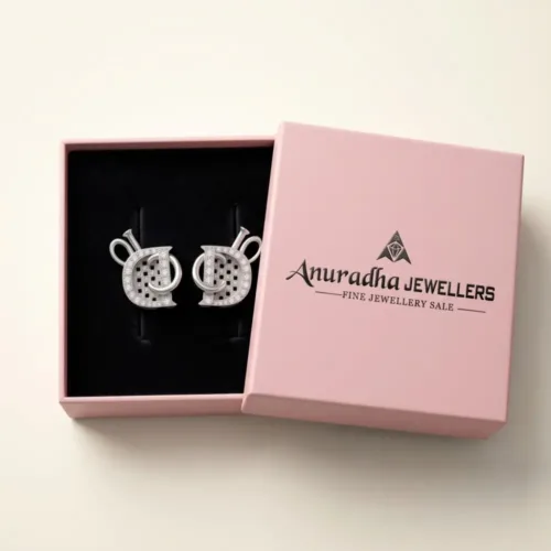The luxurious silver interlocking stud earrings securely presented inside the signature pink Anuradha Jewellers gift box on a soft black velvet tray.