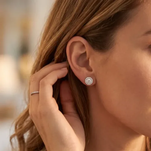 Elegant model wearing the round cz halo stud earrings, showing the perfect everyday fit and classic solitaire sparkle on the earlobe.
