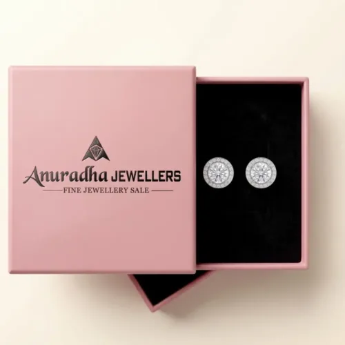 The premium silver solitaire halo earrings beautifully presented inside the signature pink Anuradha Jewellers gift box on a black velvet tray, ready for luxury gifting.