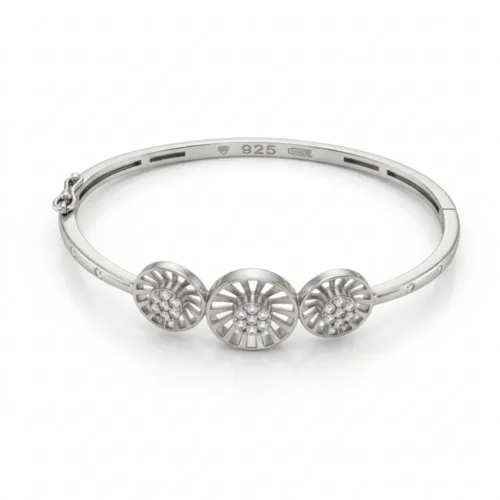 Studio view of the elegant silver sunburst bangle bracelet on a clean white background, highlighting the inner 925 hallmark and three distinct geometric medallions.