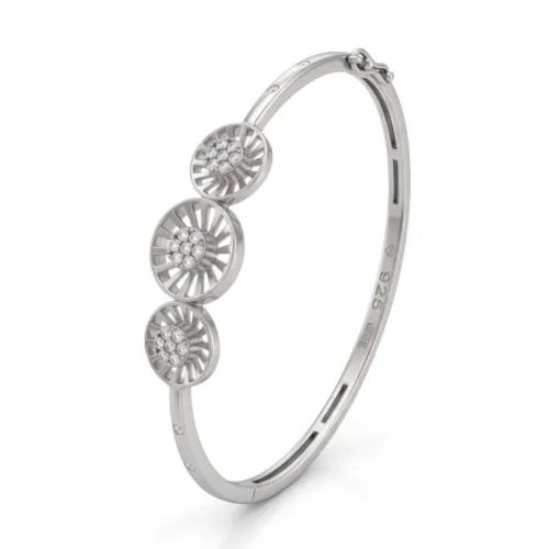 Detailed angled view of the hinged silver bangle with safety clasp, clearly illustrating the secure figure-8 side lock mechanism designed for everyday wear.