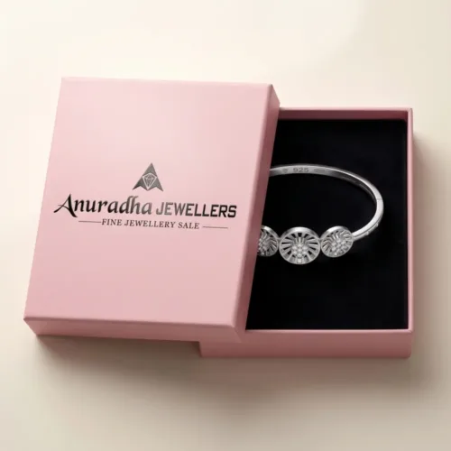 The stunning silver sunburst bangle securely packaged inside the signature pink Anuradha Jewellers gift box, perfectly presented for luxury gifting.