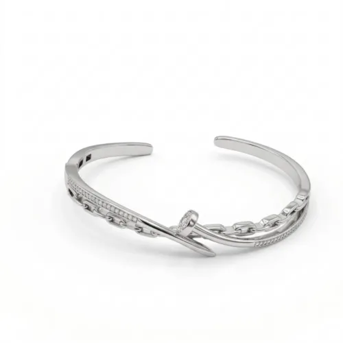 Premium silver nail cuff bracelet for women elegantly displayed on a clean white background, showcasing its wrap-around silhouette and micro-pavé cubic zirconia stones.