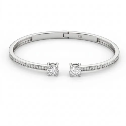 Premium toi et moi bangle bracelet silver on a clean white background, highlighting the two brilliant face-to-face center stones and the micro-pavé studded band.