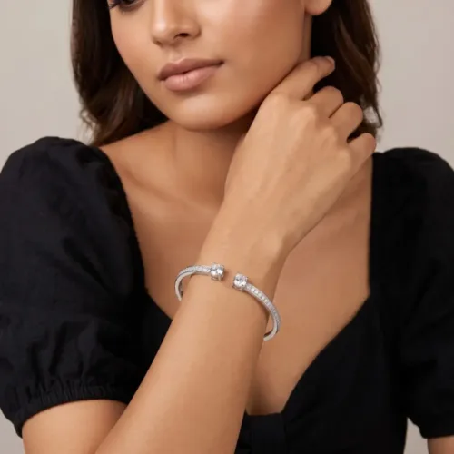 Elegant model effortlessly wearing the silver open cuff bangle bracelet for women, showcasing its modern fit and sparkling double stone design on the wrist.