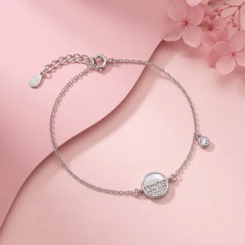 925 sterling silver bracelet with a classic LOVE inscription beautifully displayed on a soft pink background with delicate flowers.