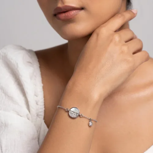 Woman wearing an elegant silver love bracelet for women, showcasing the delicate link chain and comfortable fit on the wrist.