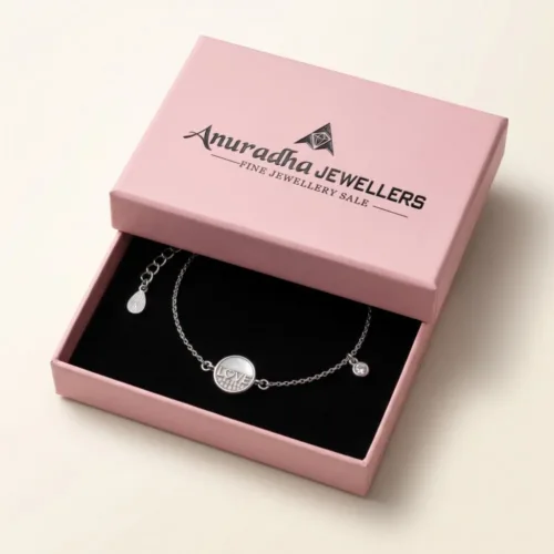Premium silver love bracelet securely placed inside a signature pink Anuradha Jewellers gift box on black velvet, ready for gifting.