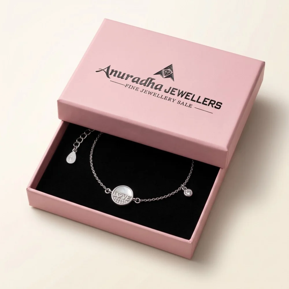 Anuradha Jewellers Premium Gift Packaging Premium silver love bracelet securely placed inside a signature pink Anuradha Jewellers gift box on black velvet, ready for gifting.