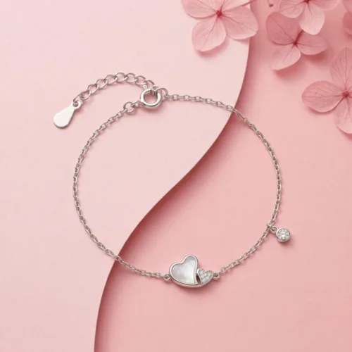 Premium 925 silver heart bracelet beautifully displayed on a soft pink background with decorative flowers.