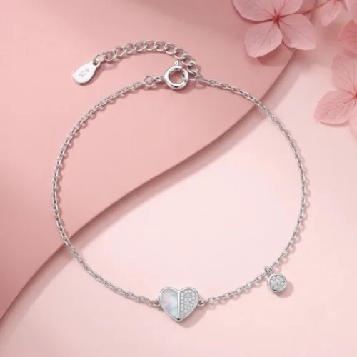 Elegant 925 silver heart bracelet for women beautifully displayed on a soft pink background with delicate floral accents.