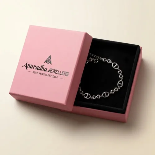 Premium silver buckle link bracelet for women securely placed inside the signature pink Anuradha Jewellers gift box on black velvet.