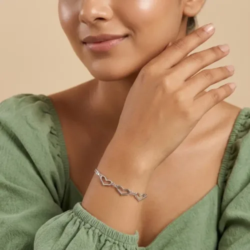 Woman elegantly wearing the double strand open heart bracelet, showcasing its comfortable fit and modern layered look for everyday style.