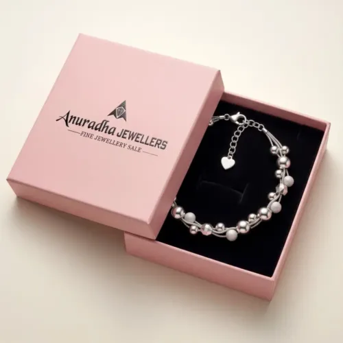 Premium multi-strand silver beaded bracelet securely placed inside the signature pink Anuradha Jewellers gift box on black velvet.