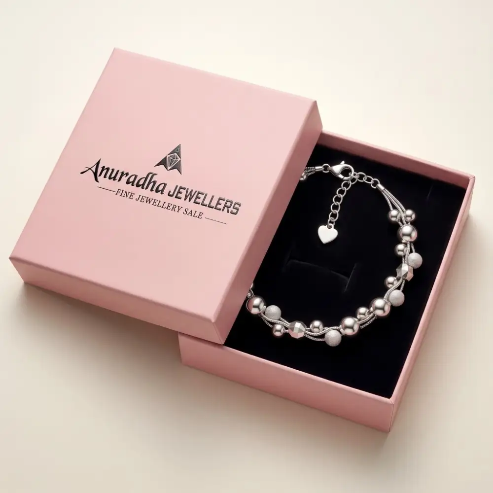 Anuradha Jewellers Premium Gift Packaging Premium multi-strand silver beaded bracelet securely placed inside the signature pink Anuradha Jewellers gift box on black velvet.
