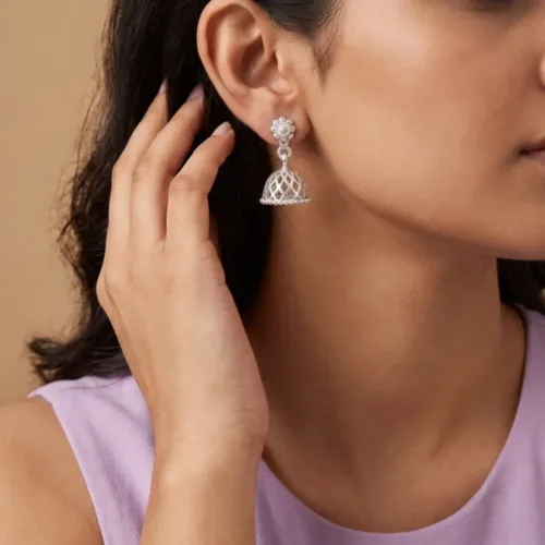 Woman wearing lightweight silver jhumki for daily wear, small jhumka earrings on ear