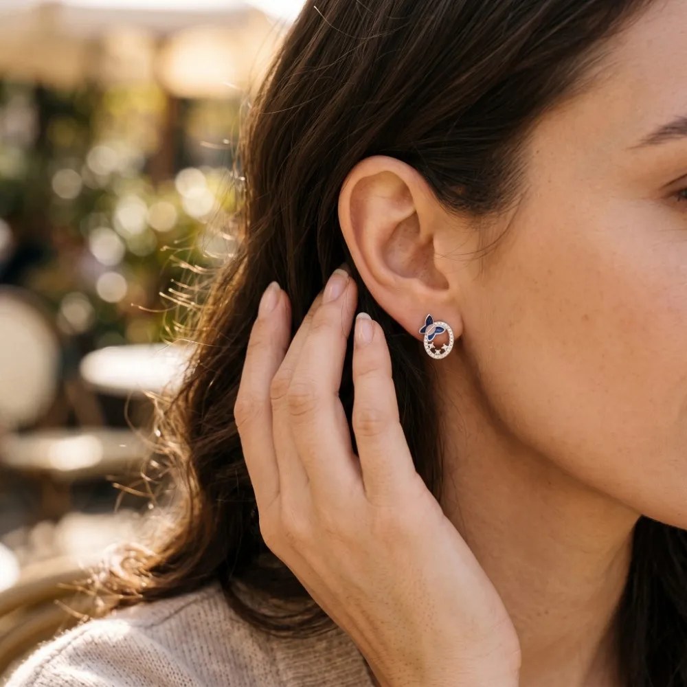 Small Silver Butterfly Earrings on Model Elegant model wearing the small silver butterfly earrings, demonstrating their petite size, comfortable fit, and perfect look for everyday styling.