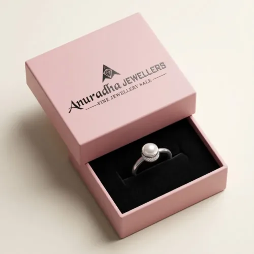 The premium silver pearl solitaire ring beautifully presented inside the signature pink Anuradha Jewellers gift box on a soft black velvet cushion, ready for gifting.